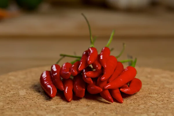 Red hot chilli peppers on a wooden table — Stock Photo, Image