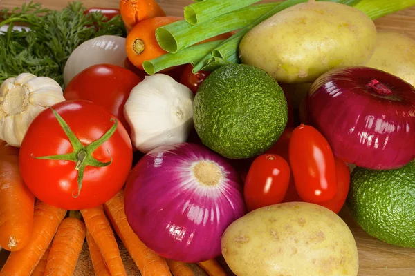 Different vegetables lying on a wooden table — Stock Photo, Image