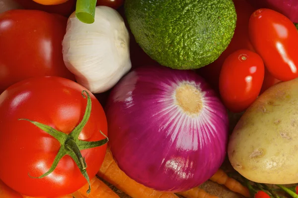 Different vegetables lying on a wooden table — Stock Photo, Image