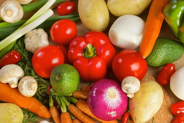 Different vegetables lying on a wooden table — Stock Photo, Image