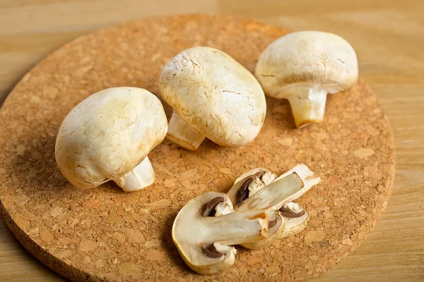 White mushrooms on the wooden background — Stock Photo, Image