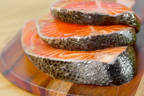 Delicious  portion of fresh salmon fillet on a wooden board — Stock Photo, Image