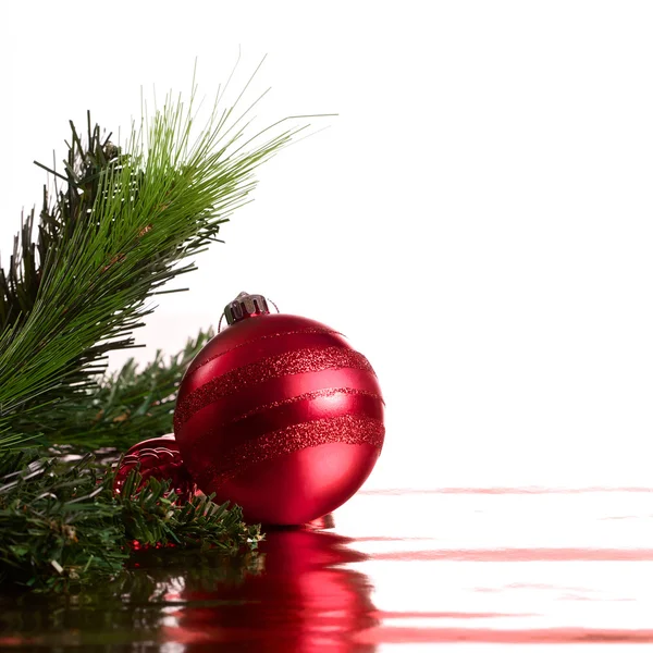 Christmas ball with green fir-tree branch — Stock Photo, Image