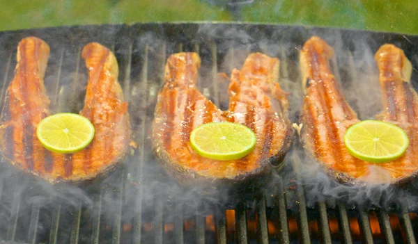 Fresh salmon fillet with lime cooked on a grill — Stock Photo, Image