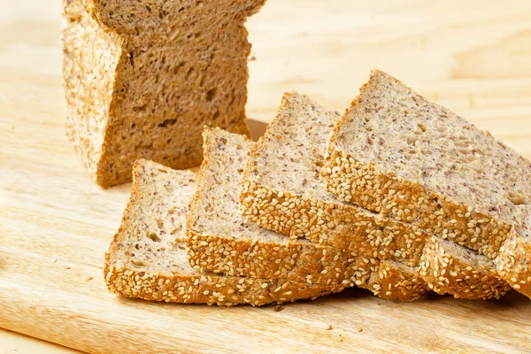 Rye bread slices on wooden table — Stock Photo, Image