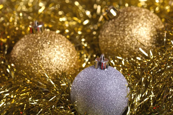 Christmas balls with yellow tinsel — Stock Photo, Image