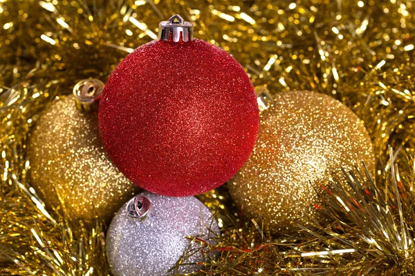 Christmas balls with yellow tinsel — Stock Photo, Image