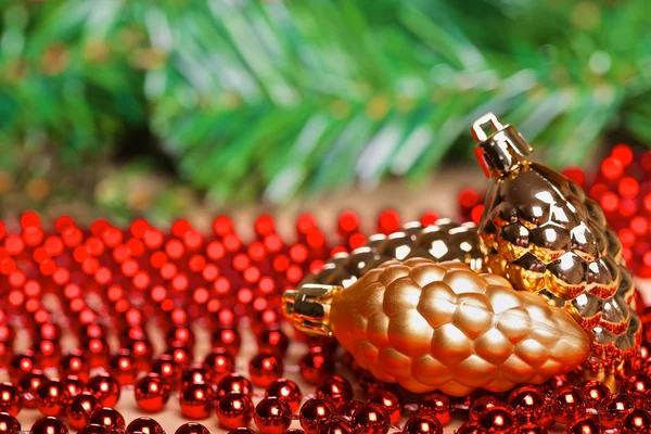 Yellow christmas ball on red beads — Stock Photo, Image