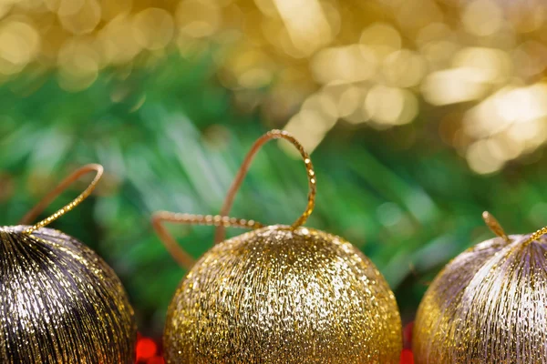 Yellow christmas balls with green fir-tree — Stock Photo, Image