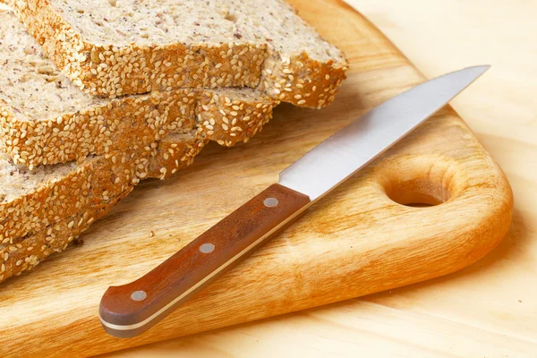 Rye bread slices on wooden table — Stock Photo, Image