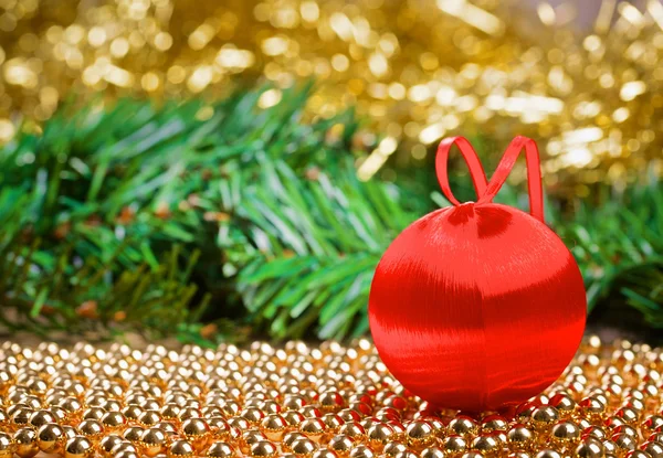 Christmas ball with yellow tinsel — Stock Photo, Image