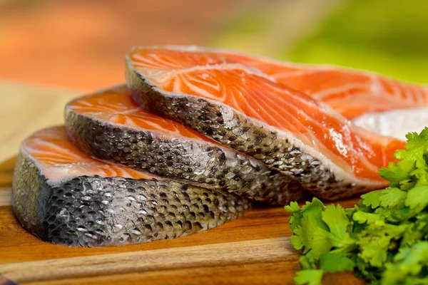 Délicieuse portion de filet de saumon frais sur une planche de bois — Photo