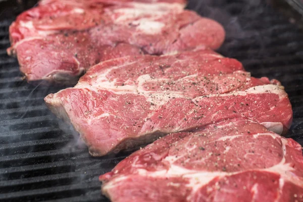 Fresh beef steaks on grill or BBQ — Stock Photo, Image