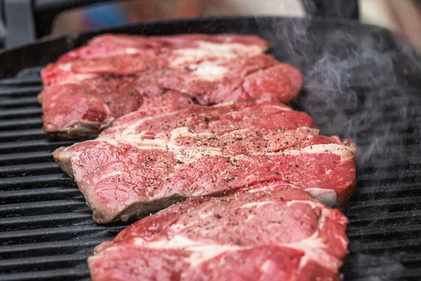 Fresh beef steaks on grill or BBQ — Stock Photo, Image