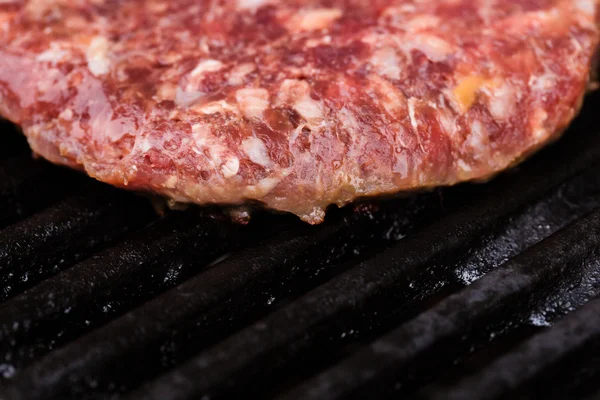 Preparing a batch of  grilled ground beef patties or frikadeller on BBQ — Stock Photo, Image