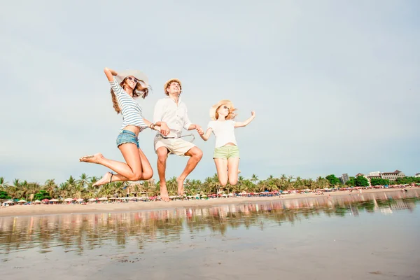 Группа счастливых молодых людей, прекрасно проводящих время на пляже — стоковое фото
