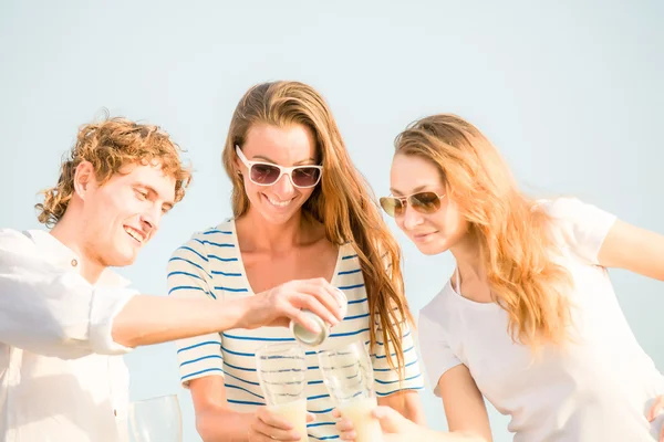 Gruppo di giovani felici che bevono birra sulla spiaggia — Foto Stock