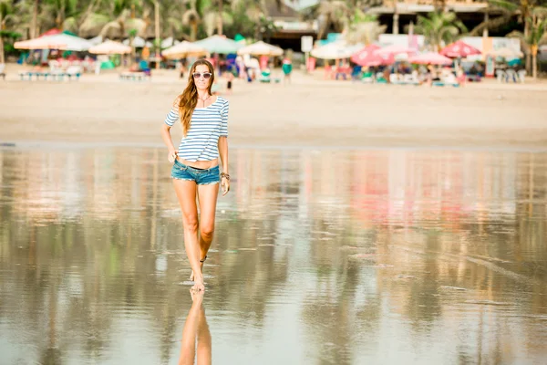 Młoda kobieta trzymać spaceru wzdłuż plaży w wakacje zachód enjoing — Zdjęcie stockowe