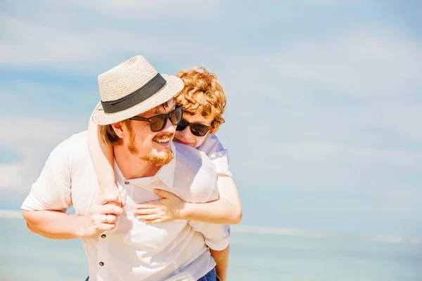 Hipster father with beard and red haired son having happy summer time at a sunny day. Concept of friendly family — Stock Photo, Image