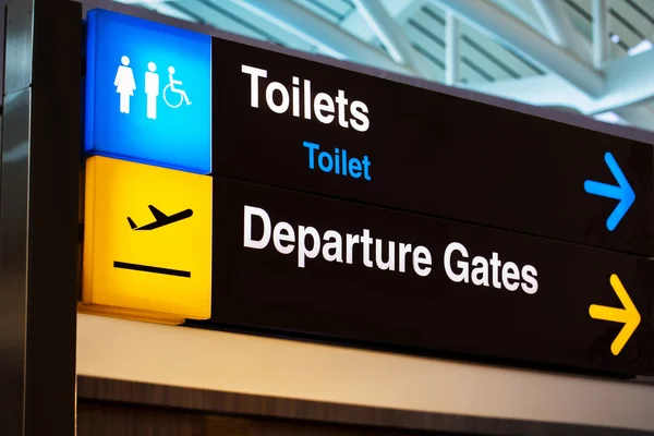 Airport sign for toilet and departure gates — Stockfoto