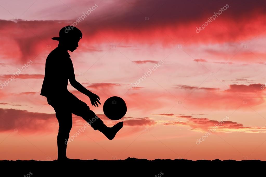 Silhouette Of A Boy Playing Football Or Soccer At The Beach With Beautiful Sunset Background Stock Photo By C Anclave