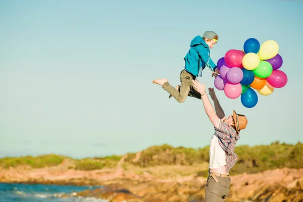 Happy father and son having great time on the beach in sunset light — Stock Photo, Image