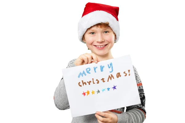 Portrait of a boy in christmas hat holding blank. Isolated — Stock Photo, Image