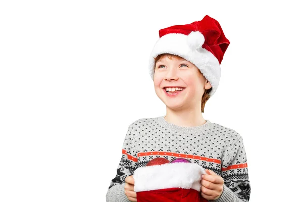 Portrait of a boy in christmas hat holdink white blank. Isolated — Stock Photo, Image