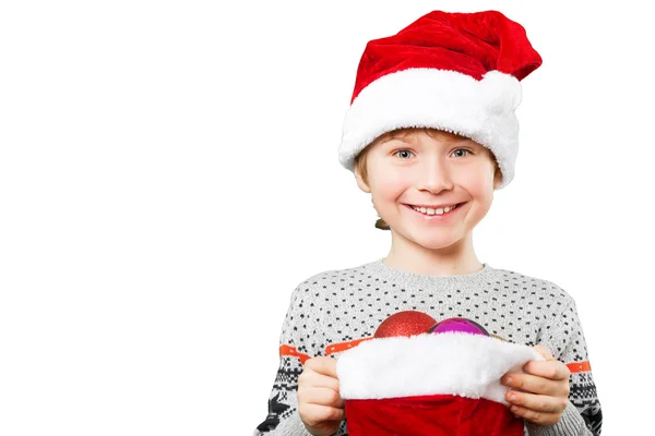 Portrait of a boy in christmas hat holdink white blank. Isolated — Stock Photo, Image
