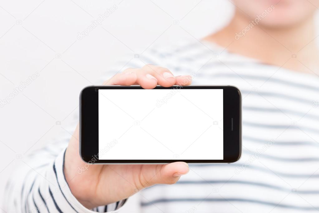 woman holding phone white screen selective focus on hand showing