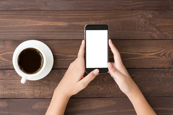 Phone white screen in woman hand on table top view — Stock Photo, Image