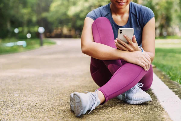 sport girl looking at phone after excercise