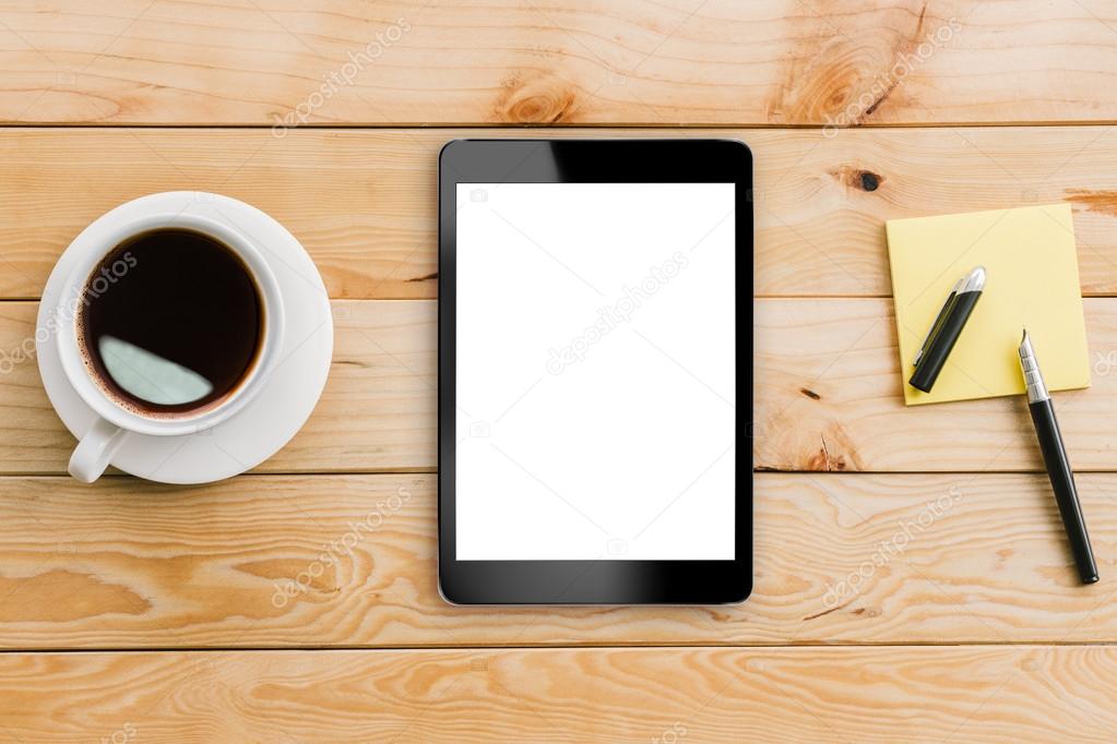 tablet white display and coffee on wood workspace