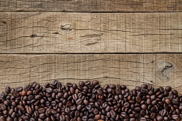 Coffee beans on grain wood — Stock fotografie