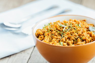 pork stir fried in a spicy with asia ingredient food on wood tab