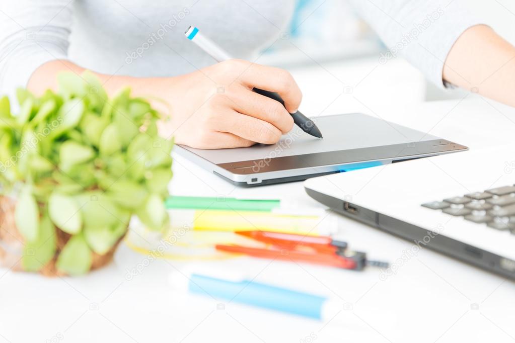 close up designer using graphic tablet design on desk