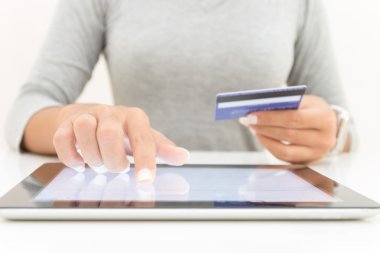 woman using tablet and credit card pay shopping online clipart