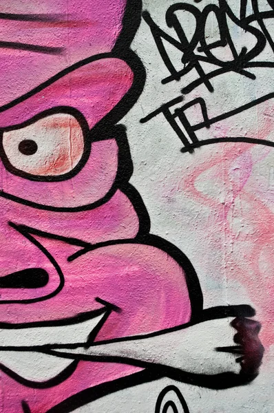 Graffiti of pink monster with cigarette — Stock Photo, Image