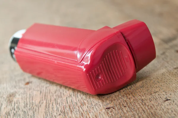 Closeup of asthma aerosol on wooden table background — Stock Photo, Image