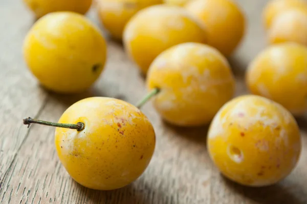Yellow plums  on wooden table background — Stock Photo, Image