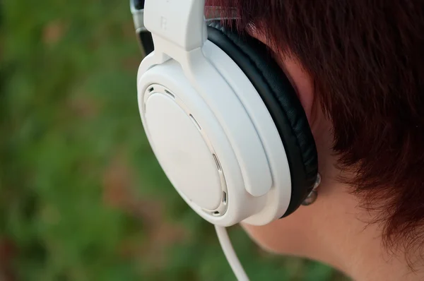 Woman with white headphones in outdoor — Stock Photo, Image