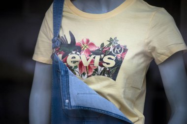 Mulhouse - France - 4 April 2021 - Closeup of yellow tee-shit by levi's on mannequin in a fashion store showroom