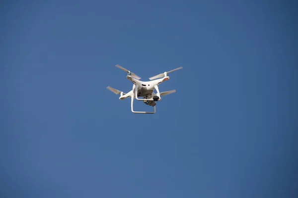 closeup of white quadcopter drone for video appllcation in outdoor on blue sky background