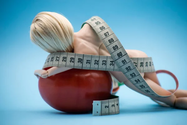 Closeup Doll Wrapped Measuring Tape Tomato Blue Background Female Fight — Stock Photo, Image