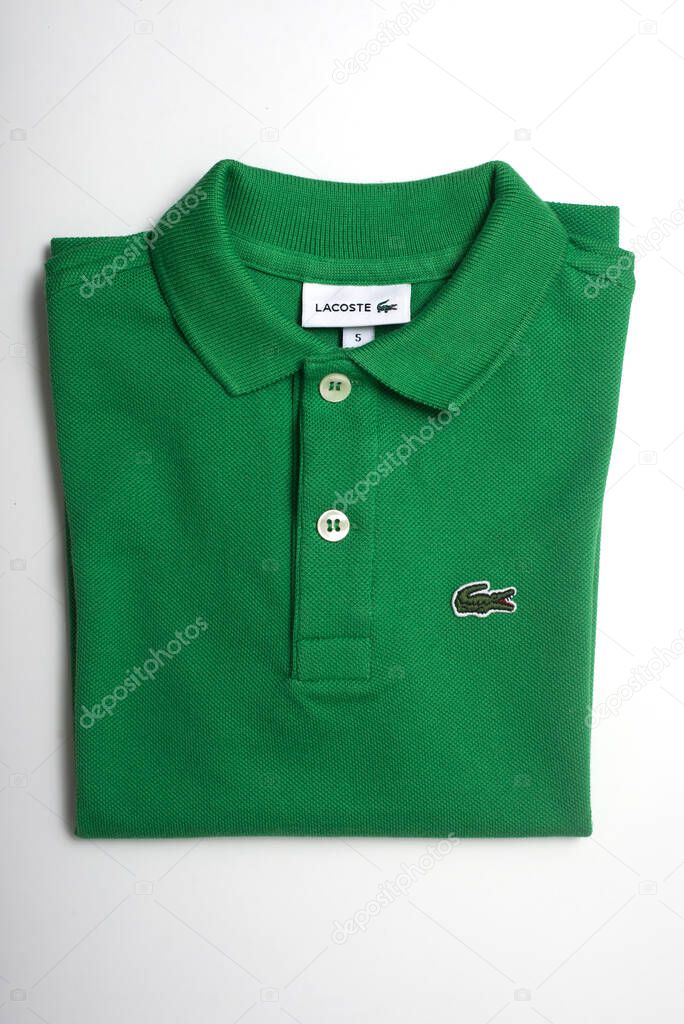 Mulhouse - France - 16 June 2021 - Closeup of green Lacoste shirt on white background, Lacoste is the famous french luxury brand of sportswear