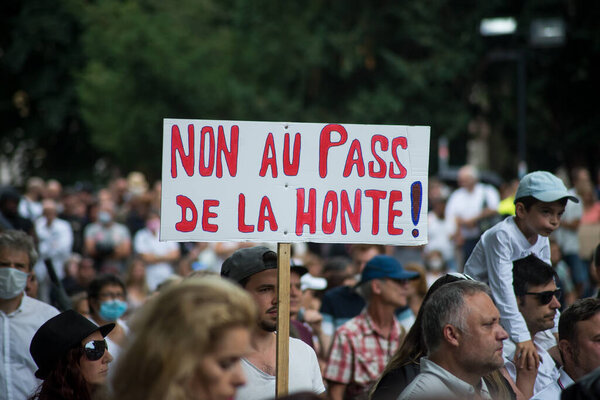 Mulhouse - France - 24 July 2021 - people protesting in the street against the sanitary pass, with banner in french, non au pass de la honte, in english , no pass of the shame