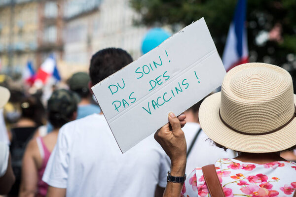 Mulhouse - France - 14 August 2021 - People protesting in the street with banner in french, du soin pas des vaccins, in english : care not vaccines