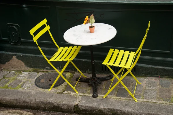 Terrace with metalic yellow chairs — Stock Photo, Image