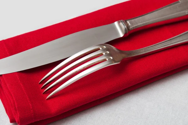 Silverware closeup on red napkin — Stock Photo, Image