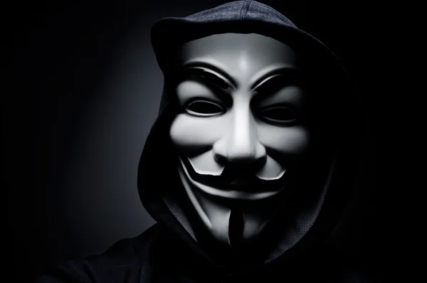 Photo of man wearing Vendetta mask. This mask is a well-known symbol for the online hacktivist group Anonymous. Also used by protesters. — Stock Photo, Image